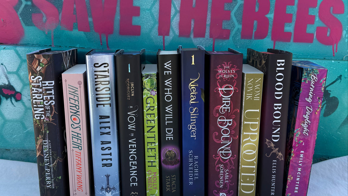 Row of books with visible titles against a colorful background with 'Save the Bees' text.