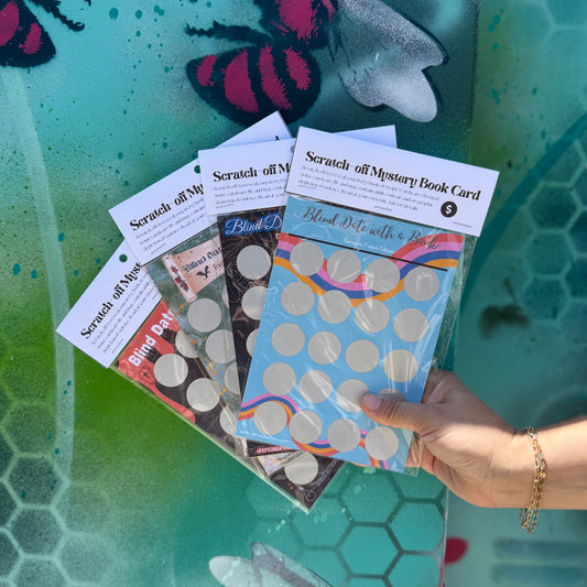 Collection of scratch-off cards held by a hand against a colorful background